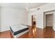 Bedroom with hardwood floors, ceiling fan, adjacent bath, and bright natural light at 10029 Netherton Dr, Las Vegas, NV 89134