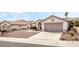 Exterior showcasing desert landscaping, an attached two-car garage, and a concrete driveway at 10029 Netherton Dr, Las Vegas, NV 89134