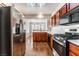 Galley kitchen with wood cabinets, stainless steel appliances, and modern lighting at 10029 Netherton Dr, Las Vegas, NV 89134