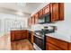 Galley kitchen with wood cabinets, stainless steel appliances, and modern lighting at 10029 Netherton Dr, Las Vegas, NV 89134