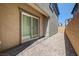 An outdoor living space features gravel, stone walkway, and a sliding glass door at 10699 Sariah Skye Ave, Las Vegas, NV 89166