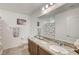 Bathroom with granite vanity and large mirror at 10699 Sariah Skye Ave, Las Vegas, NV 89166