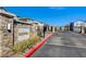 Stone entrance to Ravenna community featuring lush landscaping and secure gates at 10699 Sariah Skye Ave, Las Vegas, NV 89166