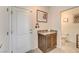 Welcoming entryway featuring tiled floors, a granite countertop cabinet, and a convenient powder room at 10699 Sariah Skye Ave, Las Vegas, NV 89166