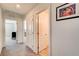 Hallway with carpeted floor leading to various rooms, each with a white door and neutral walls at 10699 Sariah Skye Ave, Las Vegas, NV 89166