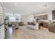 Open-concept kitchen with island seating, stainless appliances, and a seamless flow into the adjacent living area at 10699 Sariah Skye Ave, Las Vegas, NV 89166