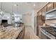 Open-concept kitchen with granite counters and stainless appliances, flowing into the living room at 10699 Sariah Skye Ave, Las Vegas, NV 89166