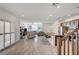 Well-lit open concept kitchen featuring an island with barstool seating, seamlessly connecting to the living area at 10699 Sariah Skye Ave, Las Vegas, NV 89166