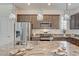 Close-up of kitchen island featuring granite countertops, stainless steel appliances, and pendant lighting at 10699 Sariah Skye Ave, Las Vegas, NV 89166