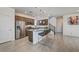 Modern kitchen featuring granite countertops, stainless steel appliances, and a breakfast bar seating area at 10699 Sariah Skye Ave, Las Vegas, NV 89166