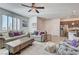 Bright living room with tile flooring, modern ceiling fan, and comfortable seating at 10699 Sariah Skye Ave, Las Vegas, NV 89166