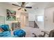 This loft features carpet, overhead fan, a butterfly art piece, and comfortable furniture at 10699 Sariah Skye Ave, Las Vegas, NV 89166