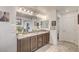 Bright main bathroom features a double vanity with granite countertops and tiled floors at 10699 Sariah Skye Ave, Las Vegas, NV 89166