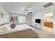 Bright main bedroom featuring a modern platform bed, ceiling fan, and ensuite bath at 10699 Sariah Skye Ave, Las Vegas, NV 89166