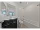 Well-lit bathroom with a bright white tub and a sink with dark cabinets at 120 Campbelltown Ave, Henderson, NV 89015