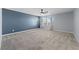 Spacious carpeted bedroom with a blue accent wall and a ceiling fan, and natural light at 120 Campbelltown Ave, Henderson, NV 89015