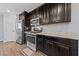 Well-equipped kitchen features stainless steel appliances, dark cabinetry, and granite countertops at 120 Campbelltown Ave, Henderson, NV 89015