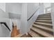 Carpeted stairs with a modern railing lead to the upper and lower floors at 120 Campbelltown Ave, Henderson, NV 89015