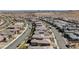 Vast aerial view showing the planned community layout with city views and neatly aligned residences at 12422 Tudor Arch Dr, Las Vegas, NV 89138