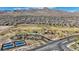 Scenic aerial view showcasing the community park with playground, sport courts, and open space with mountain backdrop at 12422 Tudor Arch Dr, Las Vegas, NV 89138