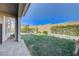 Expansive backyard featuring green grass, a patio area, and a covered pergola for entertaining at 12422 Tudor Arch Dr, Las Vegas, NV 89138