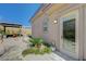 Serene backyard with custom stone pathway leading to a covered patio with dining set at 12422 Tudor Arch Dr, Las Vegas, NV 89138