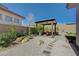 Landscaped backyard featuring gravel, stone accents, dining area and a covered pergola at 12422 Tudor Arch Dr, Las Vegas, NV 89138