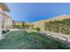 Green backyard featuring a modern gazebo with dining, green grass, and privacy wall at 12422 Tudor Arch Dr, Las Vegas, NV 89138