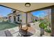 View of the covered patio featuring outdoor seating and backyard with grassy area and landscaping at 12422 Tudor Arch Dr, Las Vegas, NV 89138