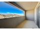 Balcony featuring views of the community and an outdoor patio, accessible via a sliding glass door at 12422 Tudor Arch Dr, Las Vegas, NV 89138