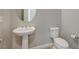 Small bathroom features pedestal sink and toilet at 12422 Tudor Arch Dr, Las Vegas, NV 89138