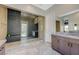 Contemporary bathroom features a glass enclosed shower, tiled floors, and a sleek vanity at 12422 Tudor Arch Dr, Las Vegas, NV 89138