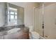 Modern bathroom with marble countertop vanity and glass enclosed shower at 12422 Tudor Arch Dr, Las Vegas, NV 89138