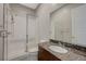 Bathroom features a glass enclosed shower, dark countertops, and a modern sink at 12422 Tudor Arch Dr, Las Vegas, NV 89138