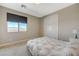 Bedroom with a large window and closet at 12422 Tudor Arch Dr, Las Vegas, NV 89138