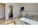 Bright bedroom features wood floors, comfortable bed, and en suite bathroom at 12422 Tudor Arch Dr, Las Vegas, NV 89138