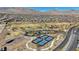 Wide aerial view of a community park with basketball court, pickleball courts, playground, and paths at 12422 Tudor Arch Dr, Las Vegas, NV 89138