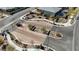 Aerial view of the community entrance and landscaped roundabout with stone features and desert landscaping at 12422 Tudor Arch Dr, Las Vegas, NV 89138