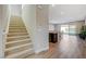 Bright foyer featuring tile floors, staircase access, and an open floor plan at 12422 Tudor Arch Dr, Las Vegas, NV 89138