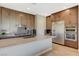 Sleek kitchen with stainless steel appliances, cooktop, and island with stone countertop at 12422 Tudor Arch Dr, Las Vegas, NV 89138