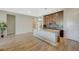 Bright kitchen with an island, modern cabinetry, and wood-look tile flooring at 12422 Tudor Arch Dr, Las Vegas, NV 89138