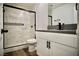 Modern bathroom with a marble-tiled shower and sleek black fixtures, and a stylish white vanity at 1254 Melville Dr, Las Vegas, NV 89102