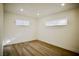 Bedroom featuring wood-look floors and large windows offering ample natural light at 1254 Melville Dr, Las Vegas, NV 89102