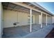 Covered patio with concrete flooring featuring support posts and exterior utility access at 1254 Melville Dr, Las Vegas, NV 89102