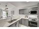 Modern kitchen showcasing white countertops, stainless steel appliances, gray cabinets, with eat in kitchen and lots of sunlight at 1800 Edmond St # 215, Las Vegas, NV 89146