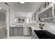 Bright kitchen with stainless steel appliances, gray cabinets, white countertops, and herringbone backsplash at 1800 Edmond St # 215, Las Vegas, NV 89146