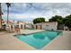 Community pool area with clear blue water, palm trees, and white lounging area at 1800 Edmond St # 215, Las Vegas, NV 89146