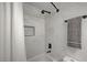 Contemporary shower with rainfall shower head and black fixtures contrasted against marble tiled walls at 1800 Edmond St # 215, Las Vegas, NV 89146