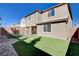 Backyard featuring artificial turf, a brick wall, a covered patio, and stone pavers at 183 Baru Belin Ave, Las Vegas, NV 89183