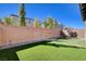 Backyard showcasing artificial turf, a brick wall, and rocks at 183 Baru Belin Ave, Las Vegas, NV 89183